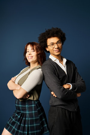 A young multicultural friends standing together in stylish attire on a dark blue background.の写真素材