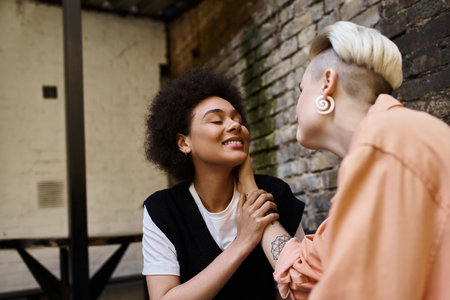 Two diverse, beautiful women standing together in a cafe.の写真素材
