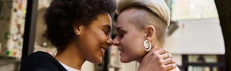Two diverse, stylish women hugging with closed eyes in a cafe.の写真素材