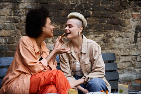 Two diverse, beautiful lesbians enjoying a coffee date in a stylish cafe.
