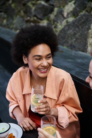 Two women enjoying a date at a cafe table.の写真素材
