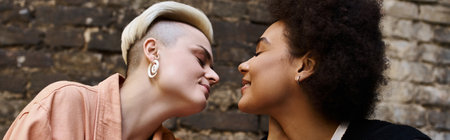 Two beautiful women stand embraced in a cozy cafe setting.の写真素材
