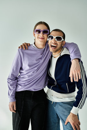 A gay couple poses wearing sunglasses.