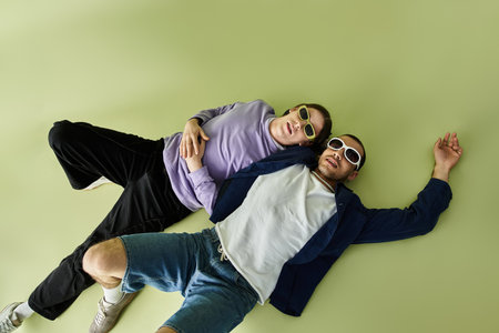 Two attractive men enjoying quality time, laying on each other.