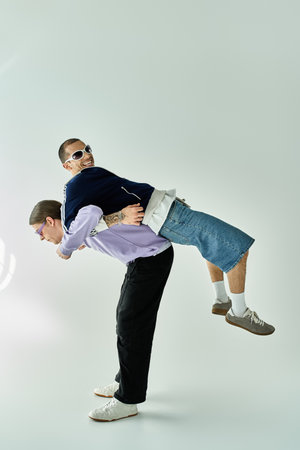 A man lifts his partner joyously into the air.