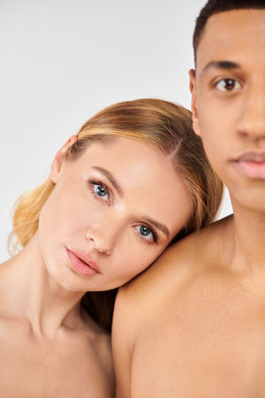 attractive man and woman embrace in intimate pose.