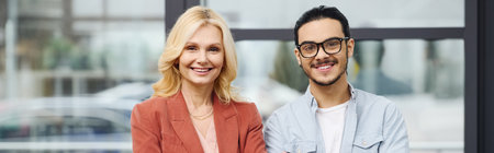 Job seeker and his employer smile warmly by a window.