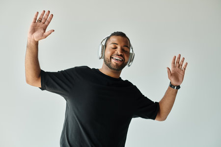 African American man in black shirt listening to headphones.の写真素材