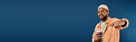 African American man in striking orange attire gestures emphatically.の写真素材