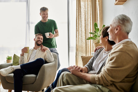 A gay couple enjoys a casual, heartwarming meeting with parents at home.の写真素材