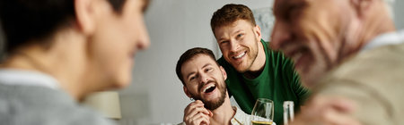 A gay couple laughs with parents during a home visit.
