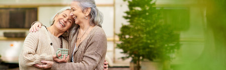A lesbian couple smiles and embraces while camping in the forest near their van.の写真素材