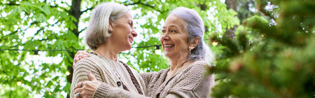 A lesbian couple enjoys a moment of intimacy while camping in a lush green forest.