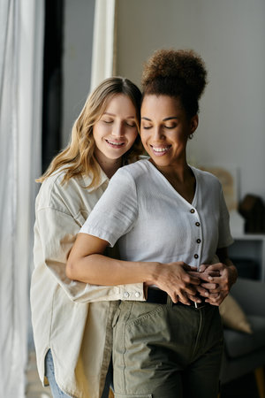 A diverse lesbian couple shares a tender moment together at home.の写真素材