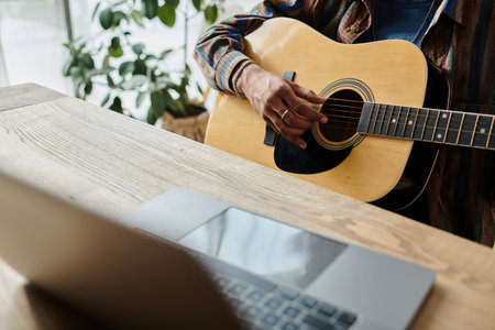 A guitarist strums passionately in front of a phone while connecting digitally.の写真素材