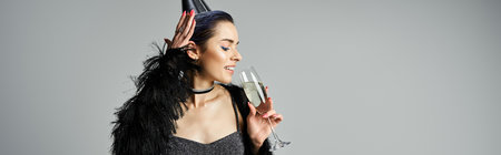 Stylish young woman in black dress holding champagne glass.