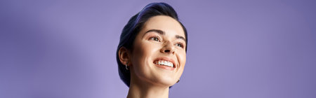 A young woman with short blue hair smiles happilyの写真素材