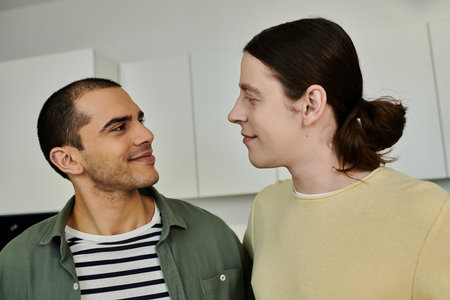 A young gay couple shares a loving moment in their modern apartment.