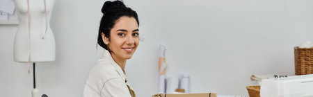 A young woman upcycles clothes in a room, smiling at camera.