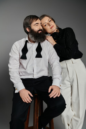 A couple dressed in formal attire poses for a portrait.