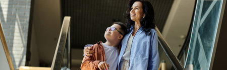 A mother and her son with Down syndrome share a warm embrace while walking through a shopping mall.
