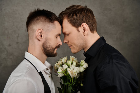 A loving gay couple in dapper suits shares a tender moment.の写真素材