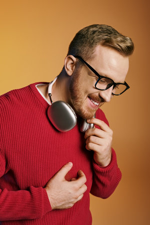 Handsome man in red sweater with headphones.