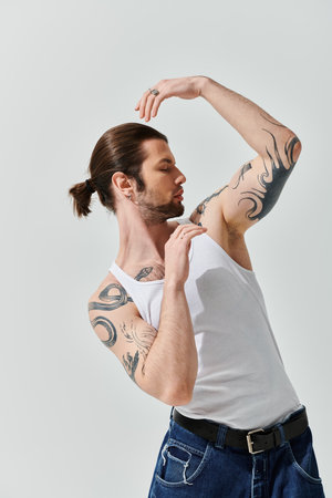 Handsome man with long hair and arm tattoos.