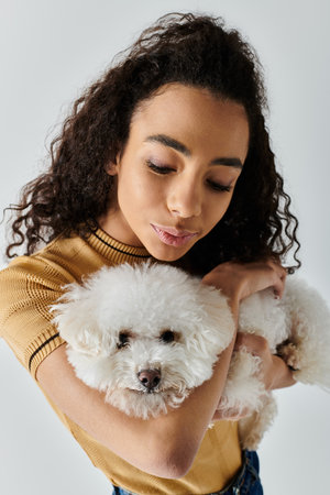 Woman tenderly holds her white dog in her arms.