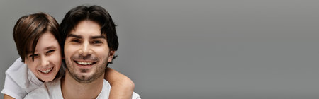 A father and son share a playful moment, both beaming with happiness.の写真素材