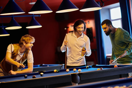Friends enjoy a casual game of billiards in a dimly lit room, laughing and talking as they play.