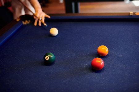 A group of friends play pool together in a relaxed setting.