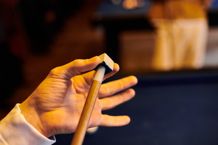 A close-up of a hand holding a billiard cue, preparing for a shot.の写真素材
