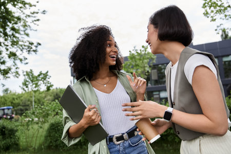 Two women, loving couple, laugh and chat.の写真素材