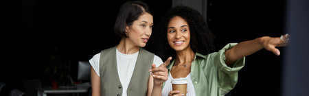 A lesbian couple works together in a modern office.