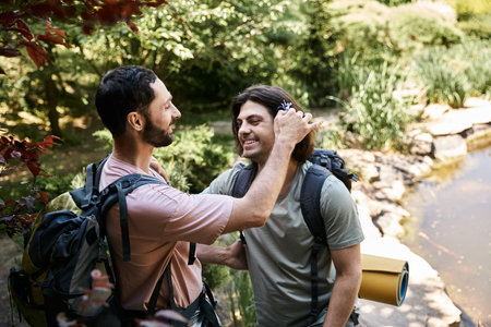 A young gay couple hikes through a lush forest in the summer, enjoying the outdoors and each others company.の写真素材