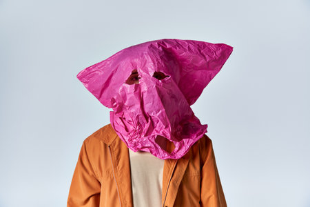 A man wearing a pink plastic bag as a mask.の写真素材