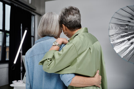 A couple embraces in a photo studio, their love radiating warmth amidst the professional setting.の写真素材