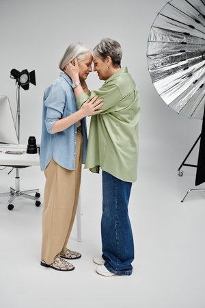 Two women in a photo studio share a tender moment