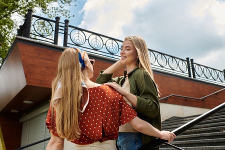 Two young women share a tender moment, enjoying a date in a city.の写真素材