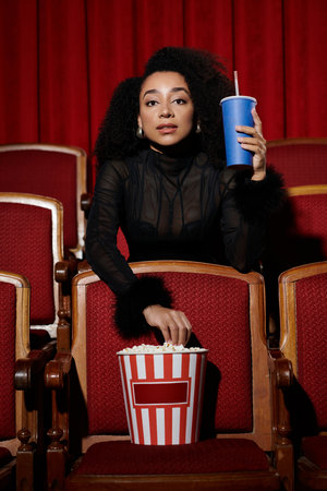 A woman in a black mesh top and chic hairdo watches a movie in a theater, immersed in the film with...