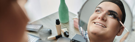 A queer person receives a touch of makeup, their smile radiant as they embrace their unique style.