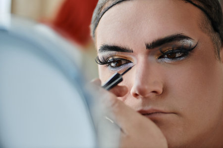 A queer person's eye is being lined with eyeliner.の写真素材