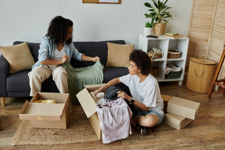 Couple joyfully upcycling clothes together in their stylish home.の写真素材