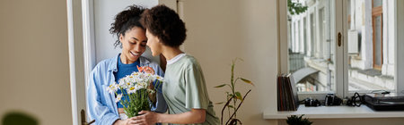 A loving couple shares a sweet moment, surrounded by nature's beauty indoors.の写真素材