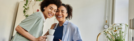 Two women share laughter and coffee in a cozy home environment.