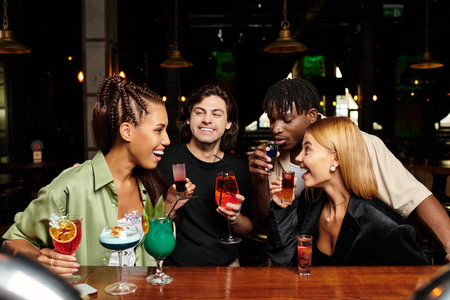 A lively gathering where young professionals celebrate, sharing drinks and laughter.の写真素材