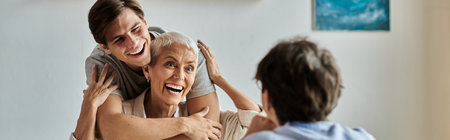 A loving LGBTQ family shares laughter and joy during a gathering in their warm, welcoming kitchen.の写真素材