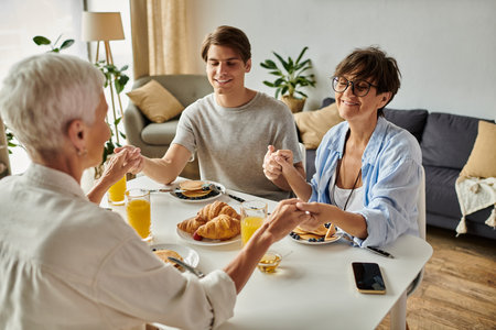 A joyful breakfast gathering features lesbian parents and their adult son sharing love and laughter.