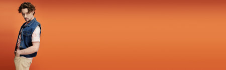 A stylish man stands confidently, showcasing his emotional depth amidst vivid colors.の写真素材